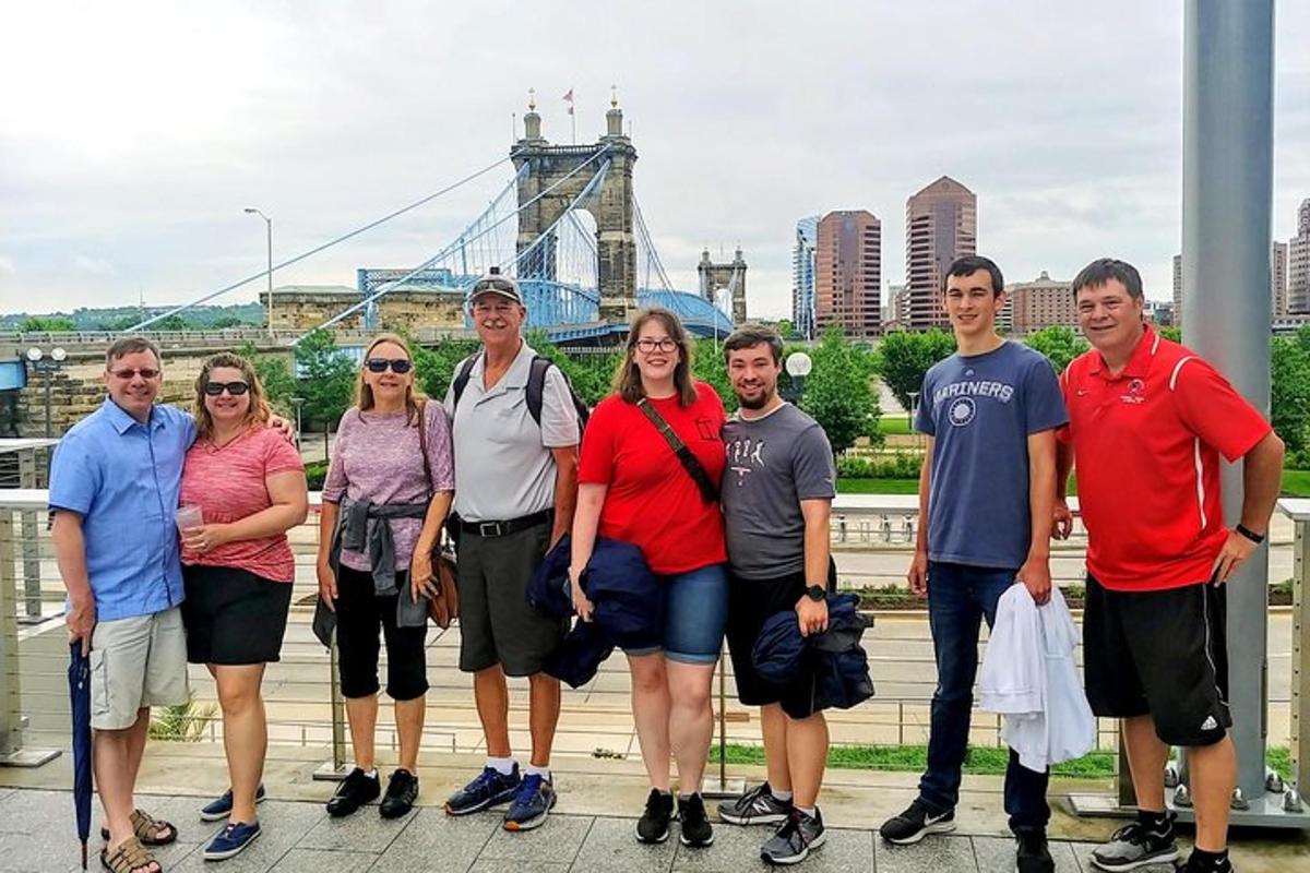 a group of people standing in front of a bridge