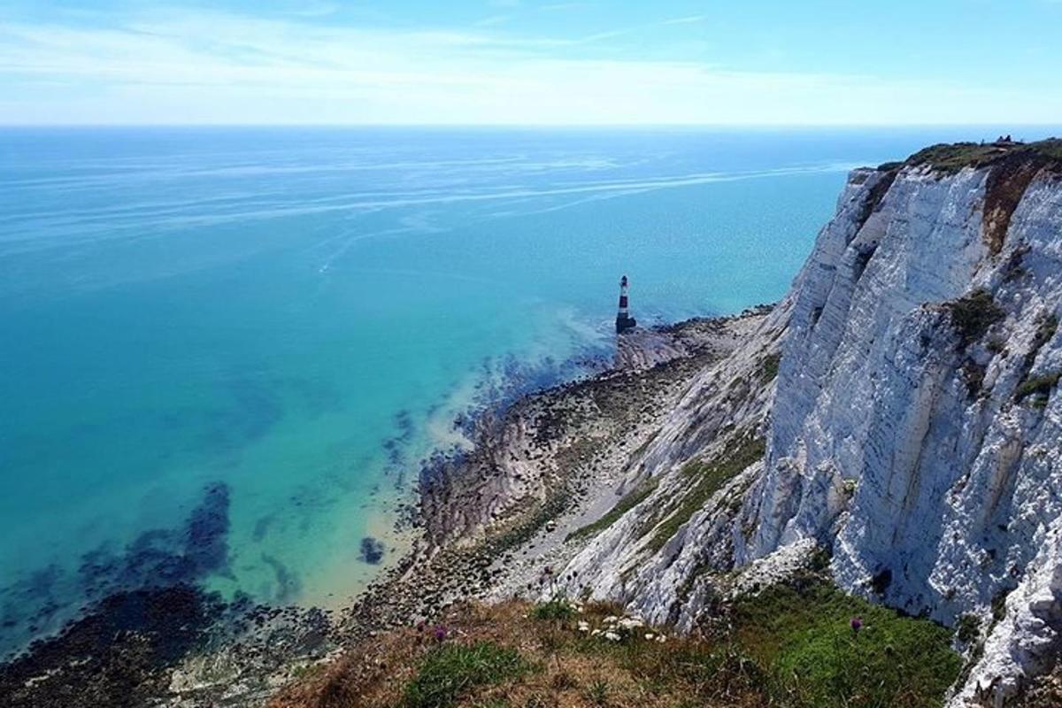 a lighthouse on the edge of a cliff near the ocean
