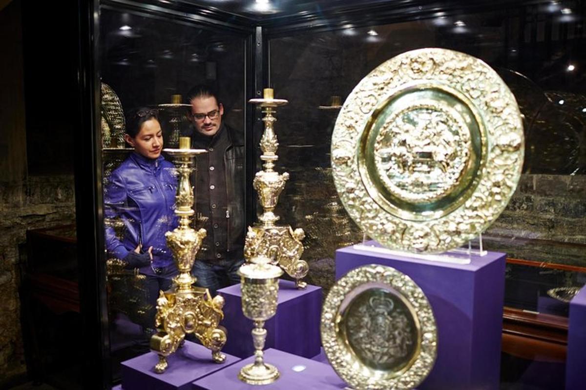 two men standing next to a display of plates and vases
