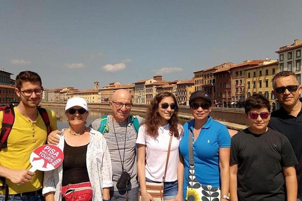a group of people posing for a picture on a bridge