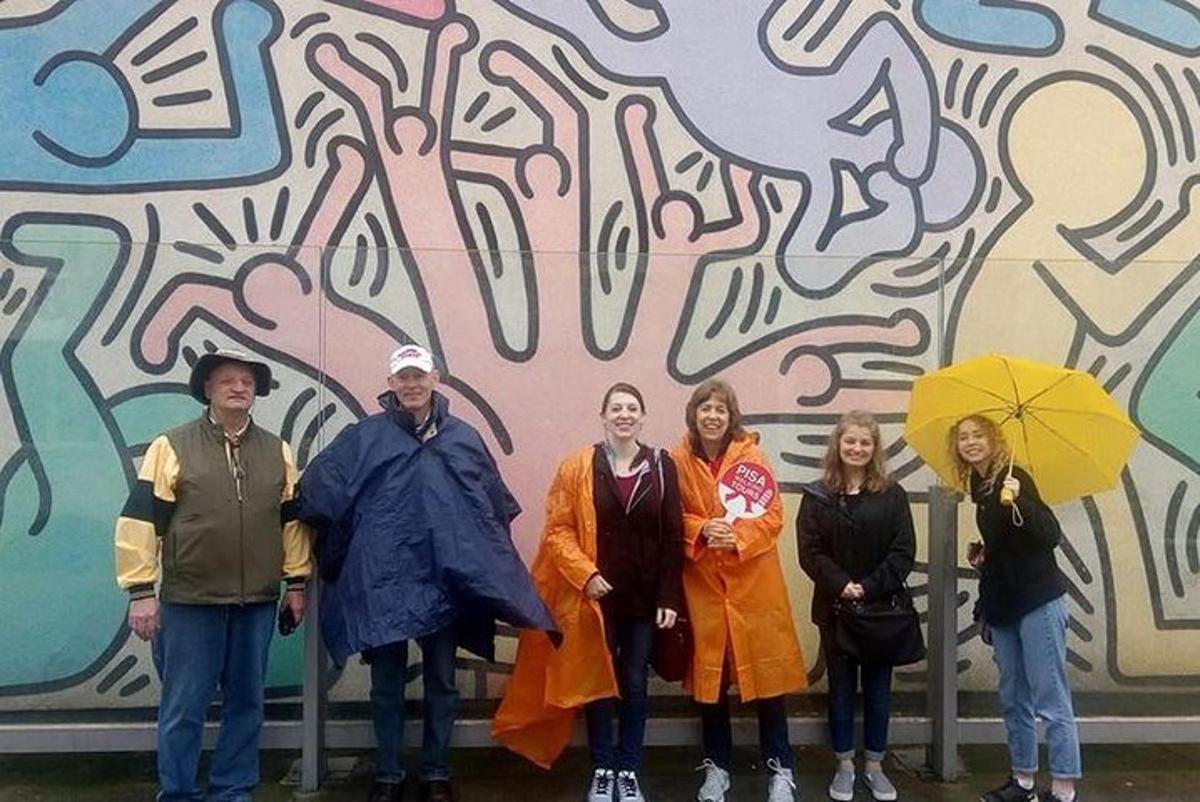 a group of people standing in front of a wall