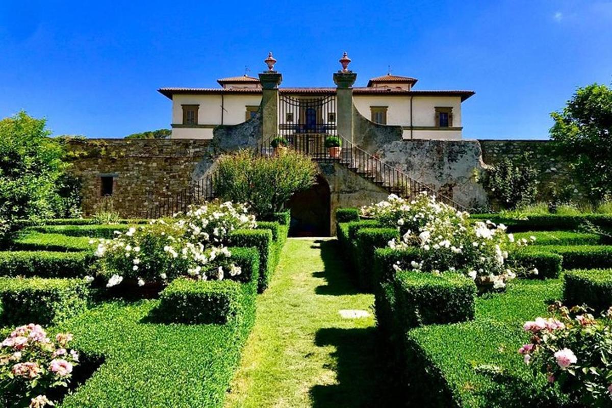 ein Haus mit einem Garten mit Büschen und Blumen