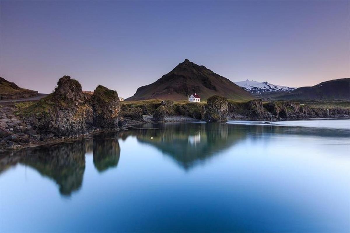 a large body of water with mountains in the background