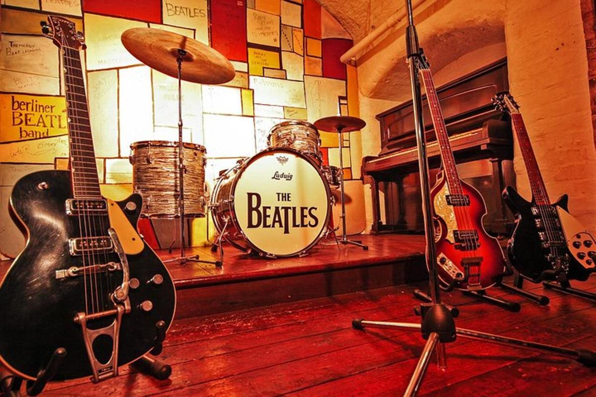 a room filled with guitars and a drum set