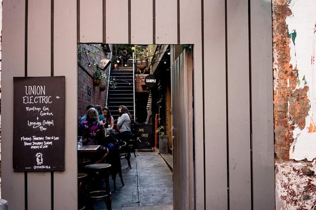 a group of people sitting at tables outside a restaurant