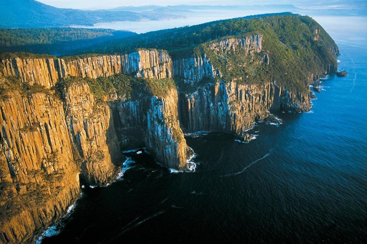 an aerial view of a large rocky island in the water