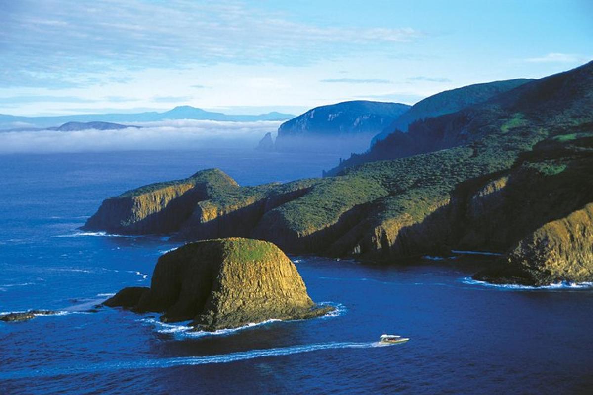 a view of the ocean with rocks in the water