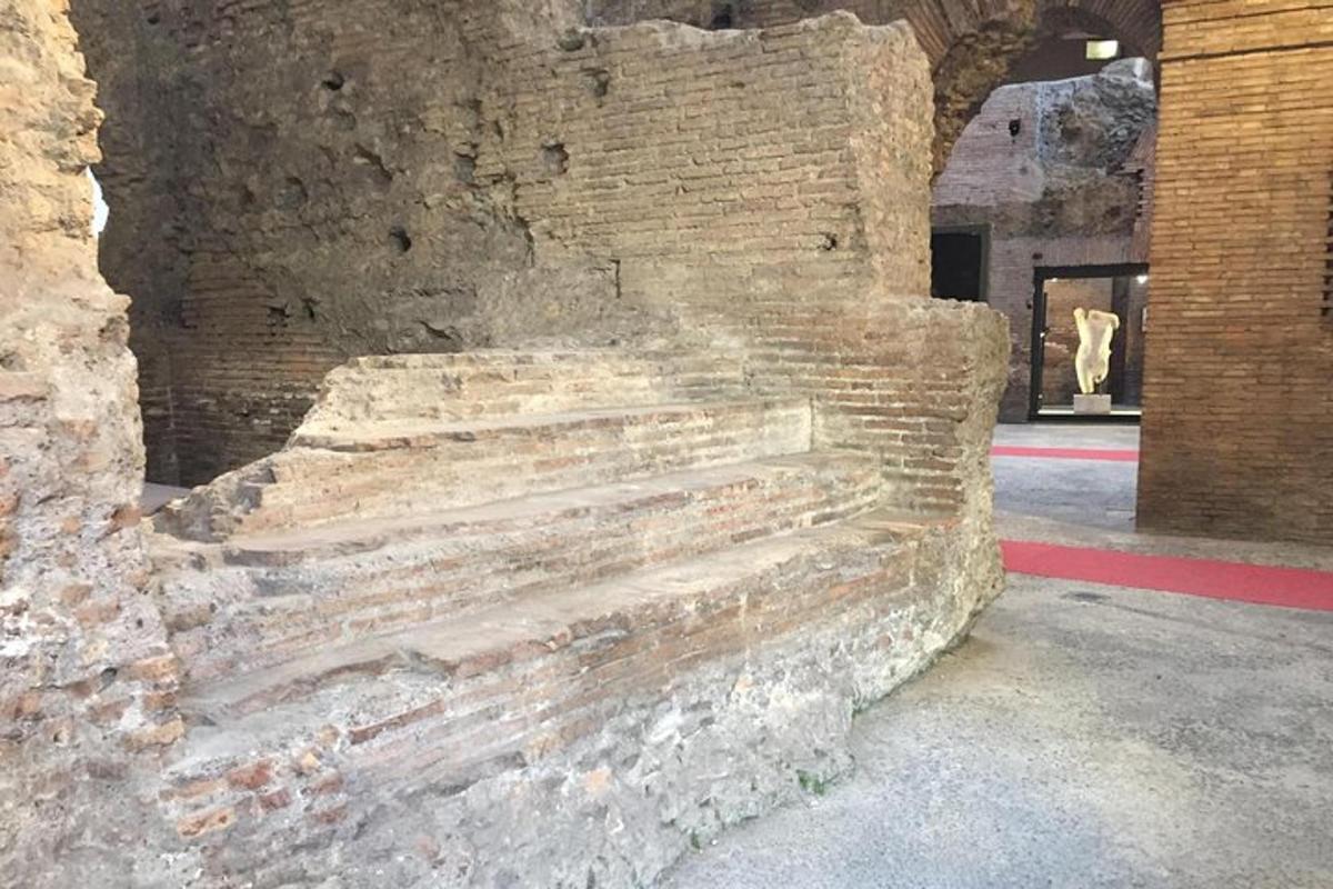 a brick wall in a building with a cow in the background