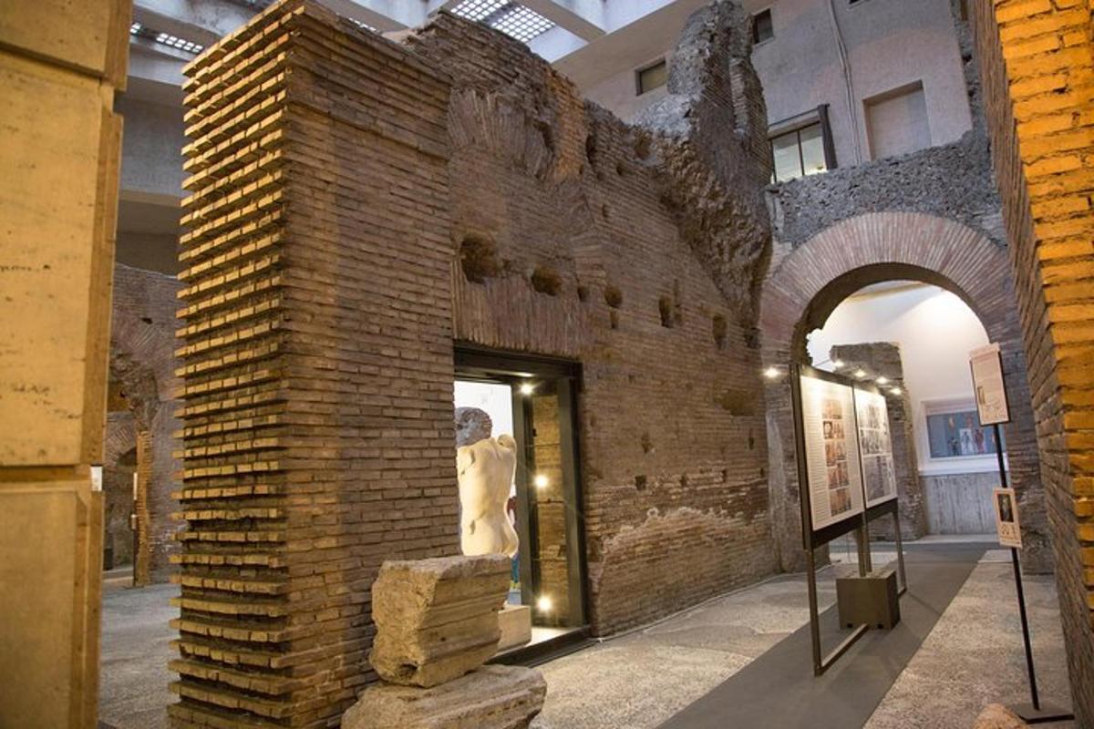 a brick wall in a museum with a statue in it