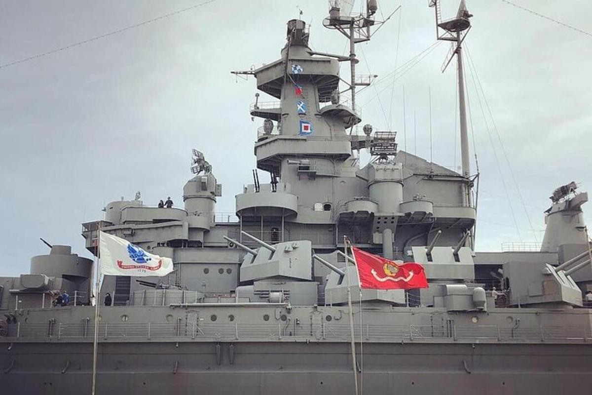 a large battleship with flags on it