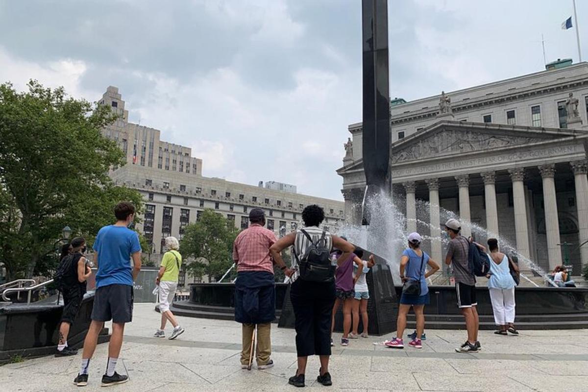 a group of people standing in front of a fountain