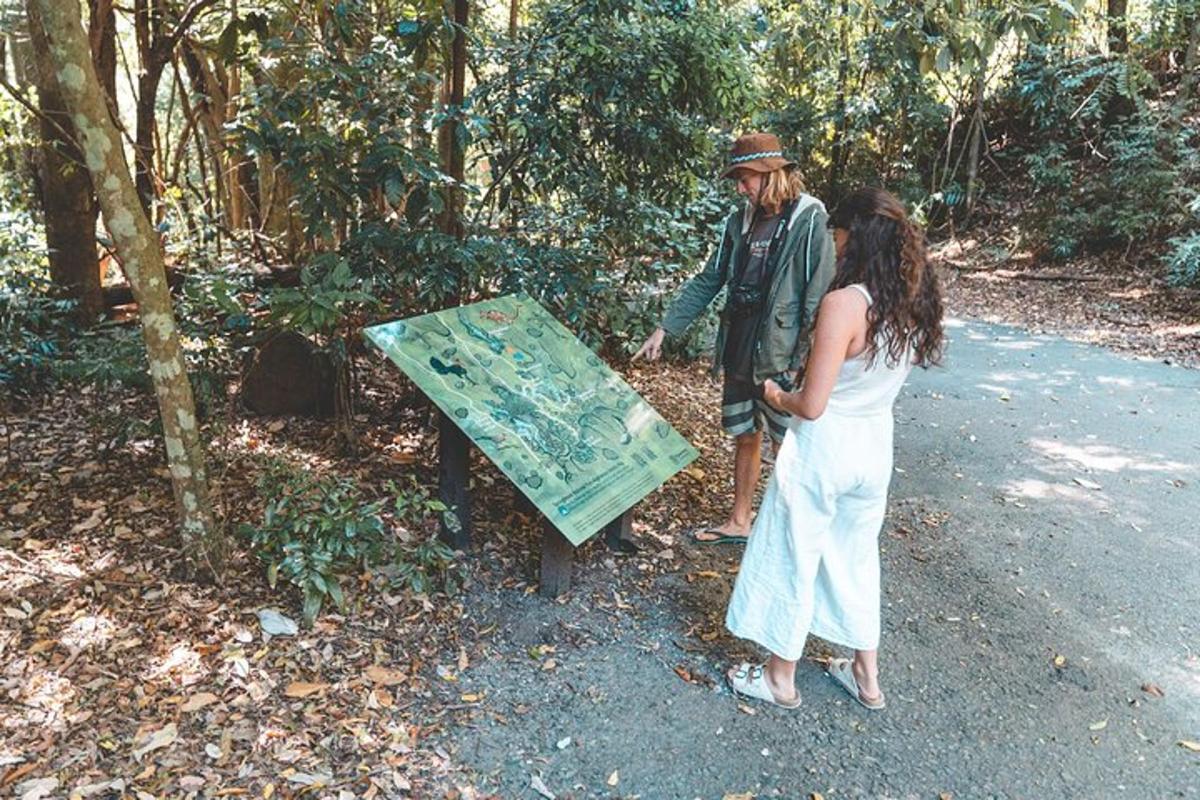 a man and a woman standing next to a sign