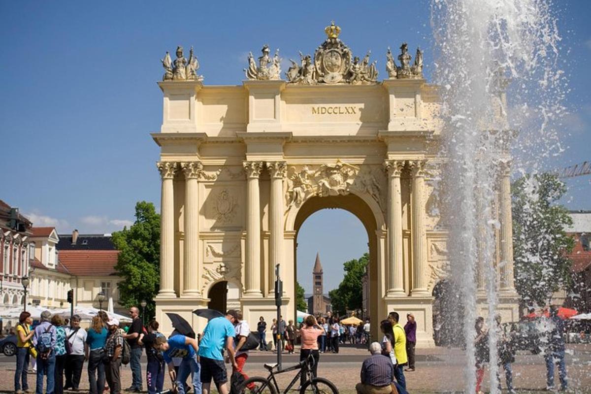 a group of people standing in front of a fountain