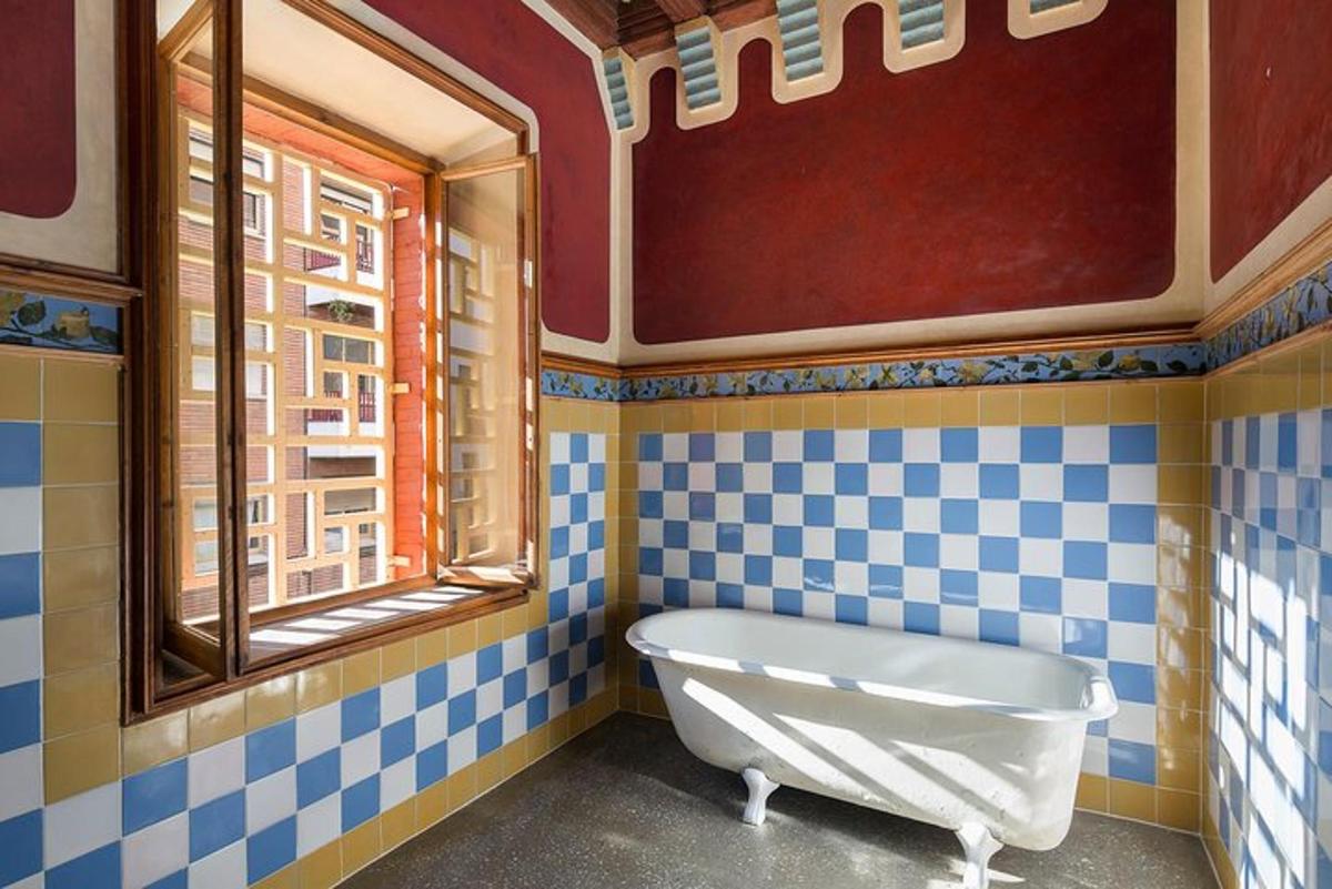 a bath tub in a bathroom with blue and white tiles