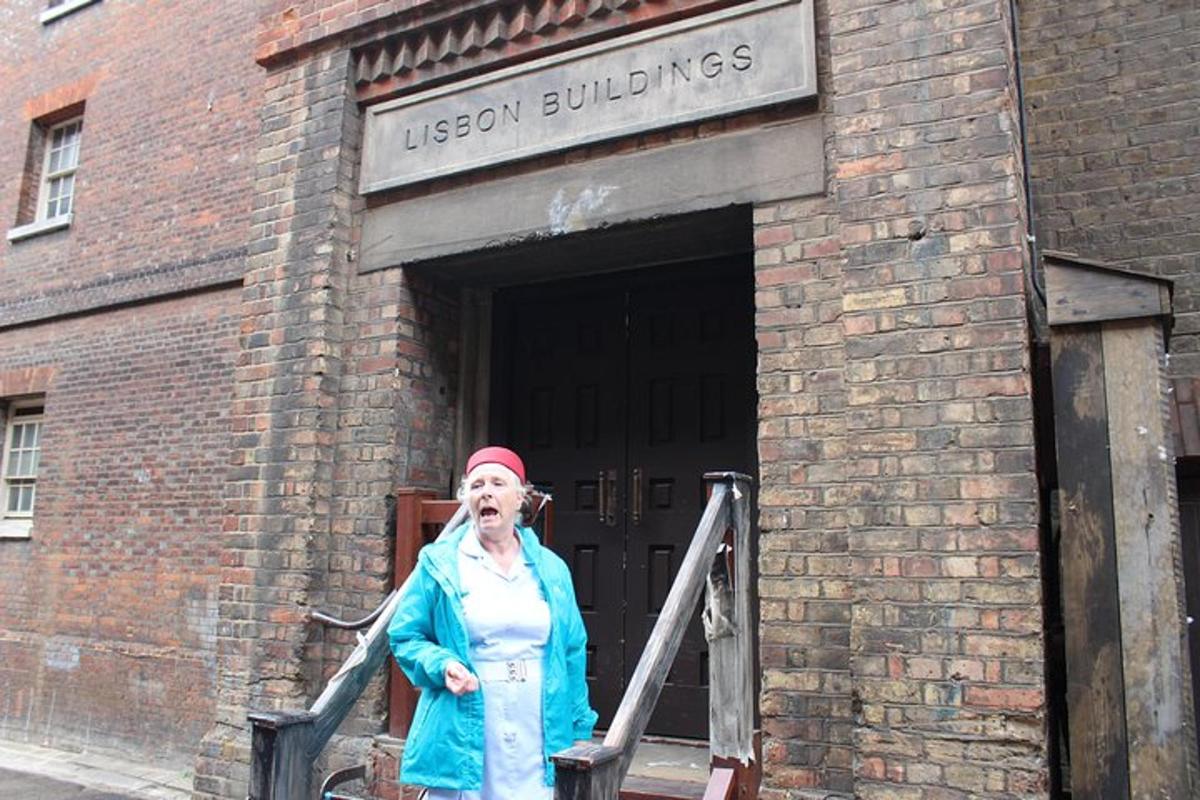 an older woman standing in a doorway of a brick building