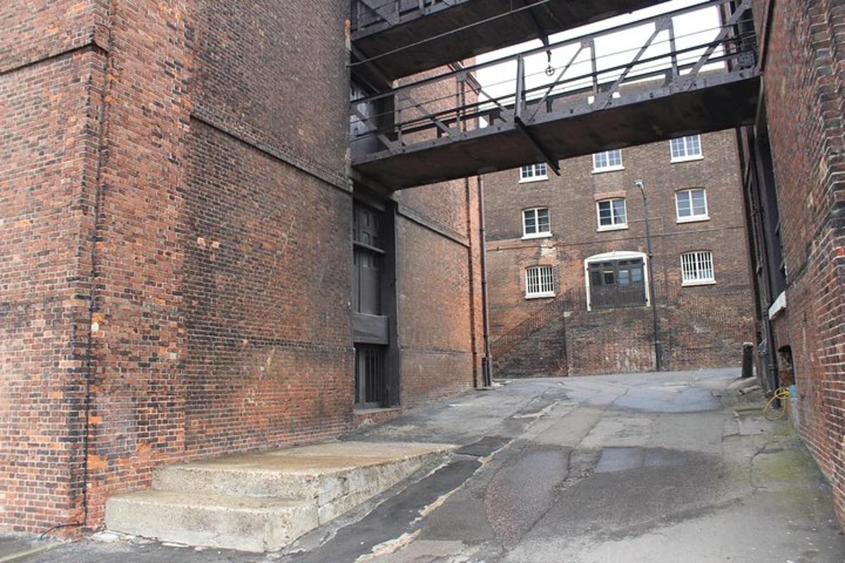 an empty brick building with stairs in front of it