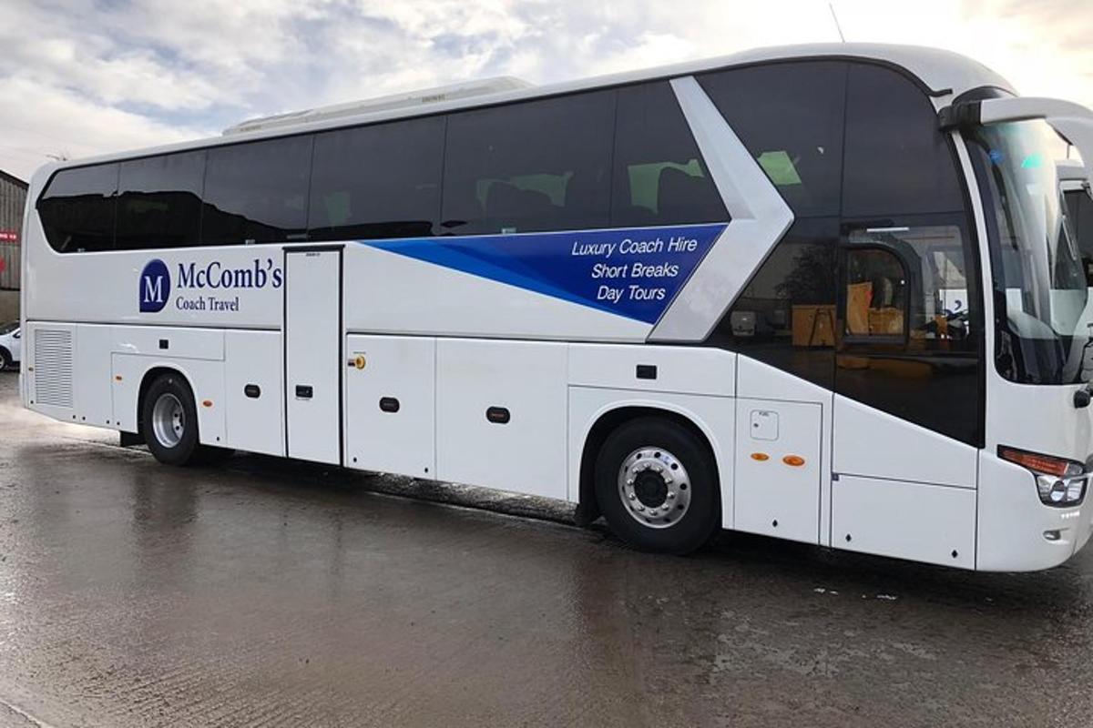 a large white bus parked in a parking lot