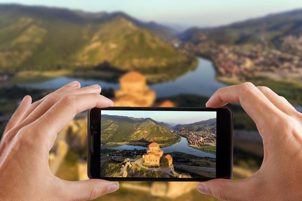 a person holding up a cell phone to take a picture