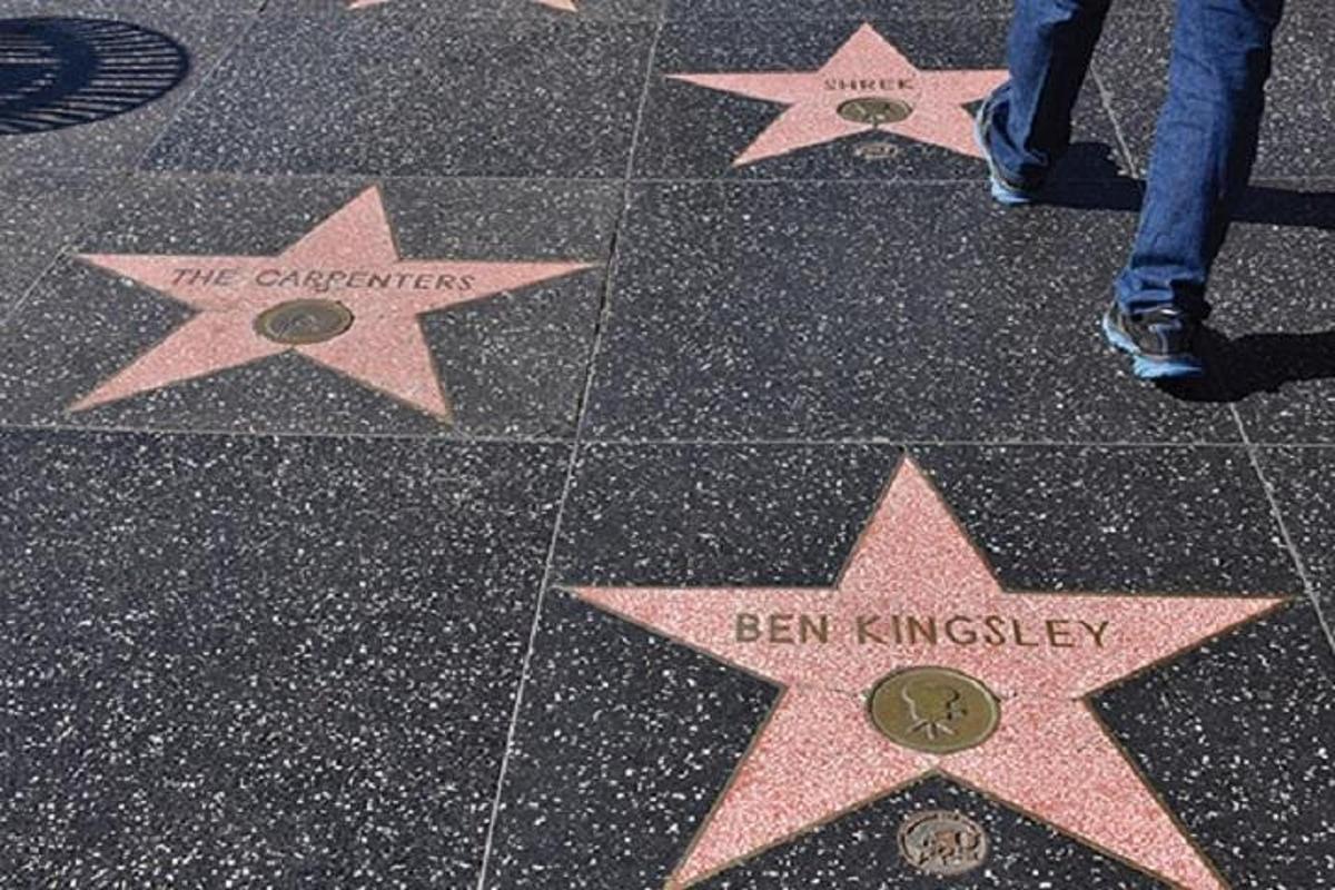 a person standing on the stars on a sidewalk