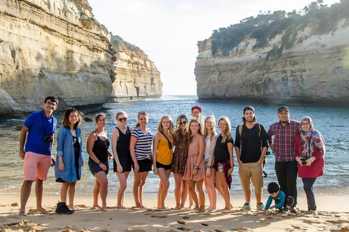 a group of people posing for a picture on the beach