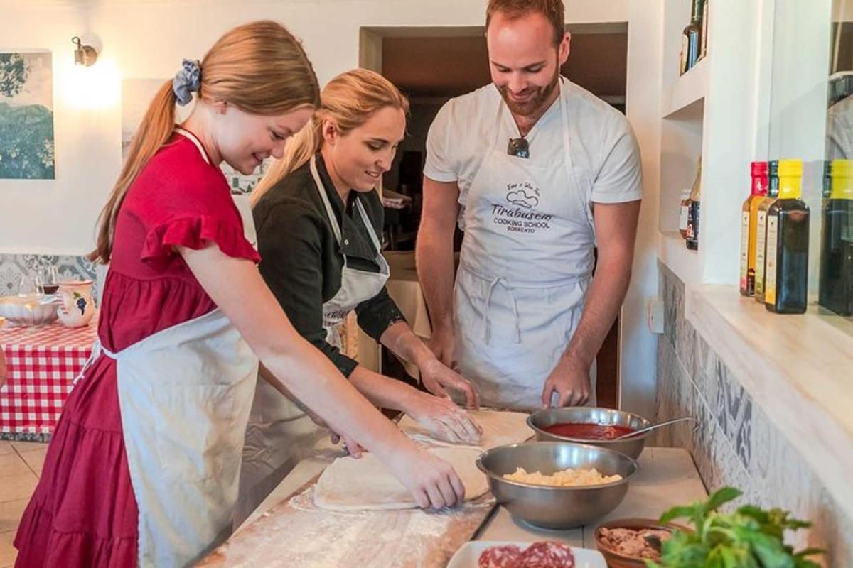a man and two women standing in a kitchen preparing food