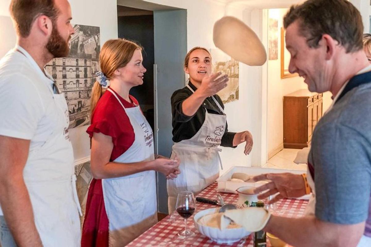 a group of people standing in a kitchen preparing food
