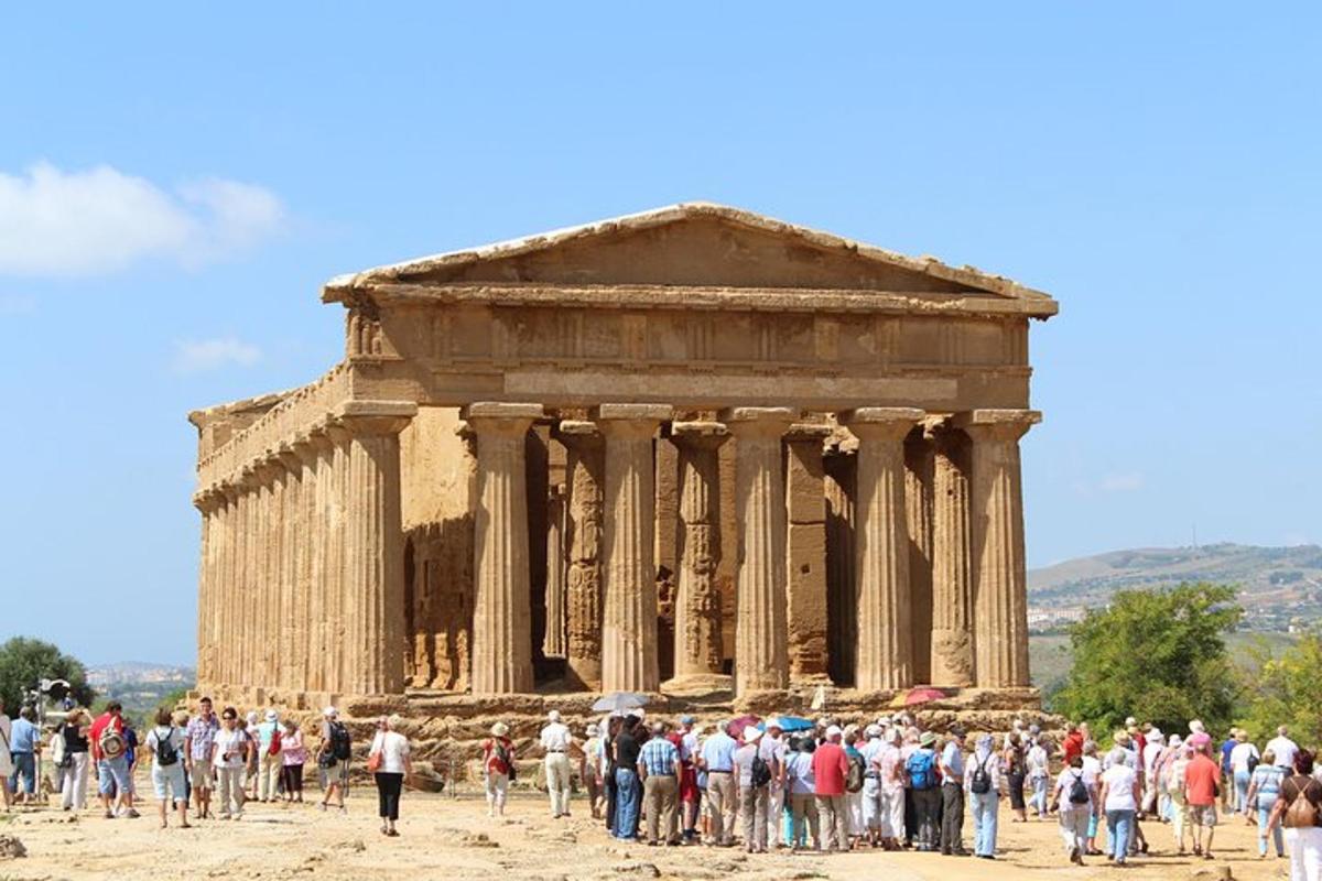 a crowd of people standing in front of a temple