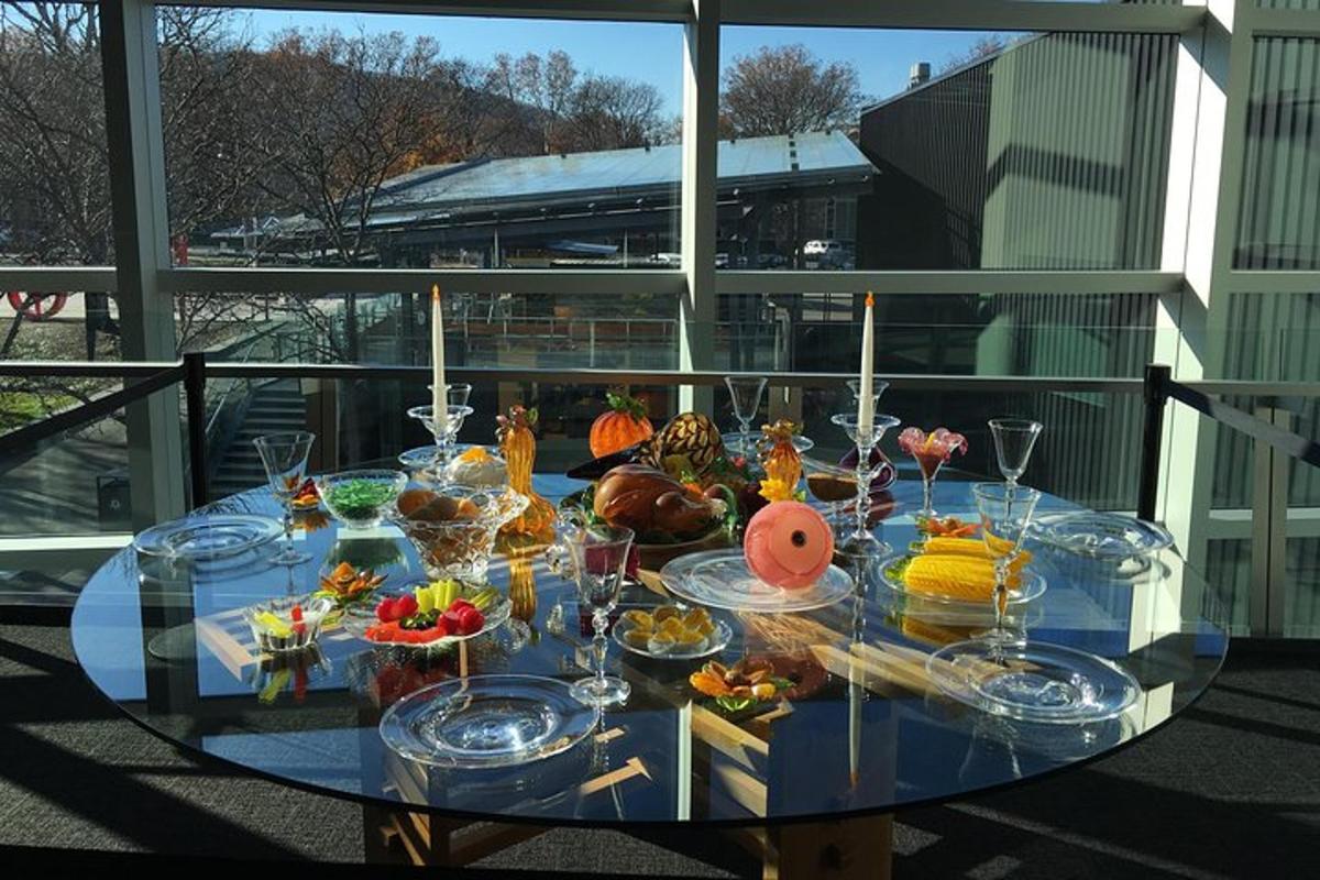 a glass table with food on it on a balcony