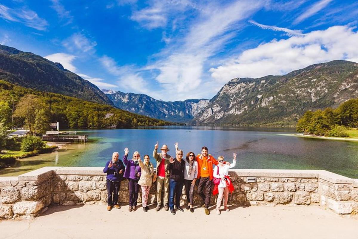 a group of people standing in front of a lake