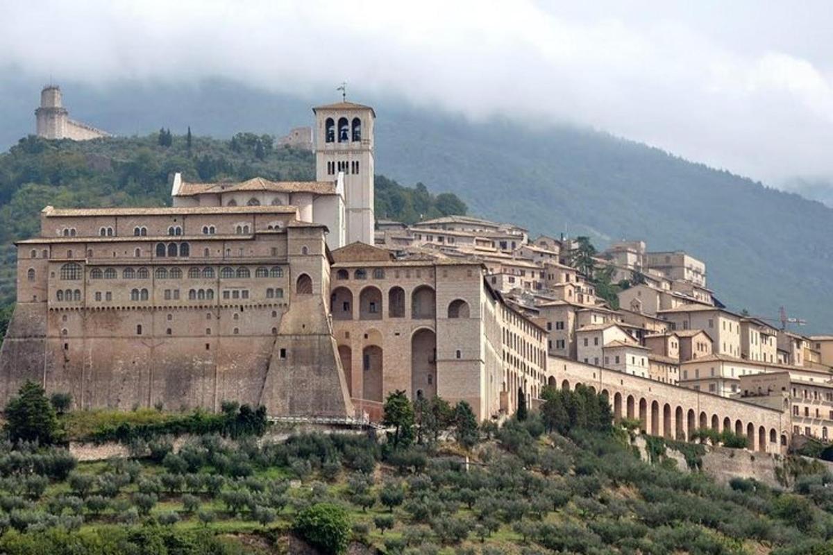 a large building with a clock tower on a hill