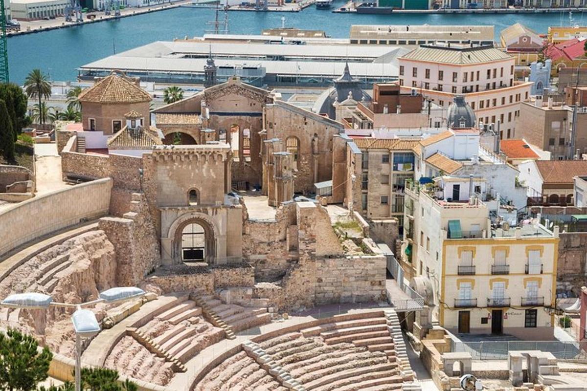 an aerial view of an ancient amphitheater in a city