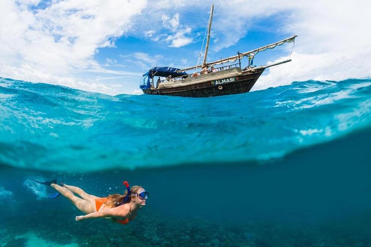 a woman swimming in the ocean next to a boat