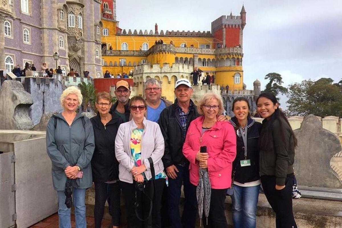 a group of people standing in front of a castle