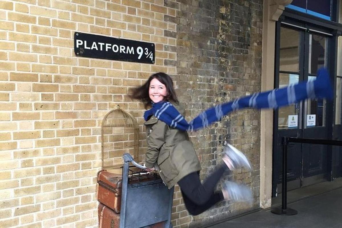 a woman is jumping off the side of a brick building