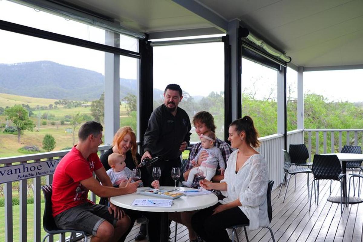 a group of people sitting around a table on a porch