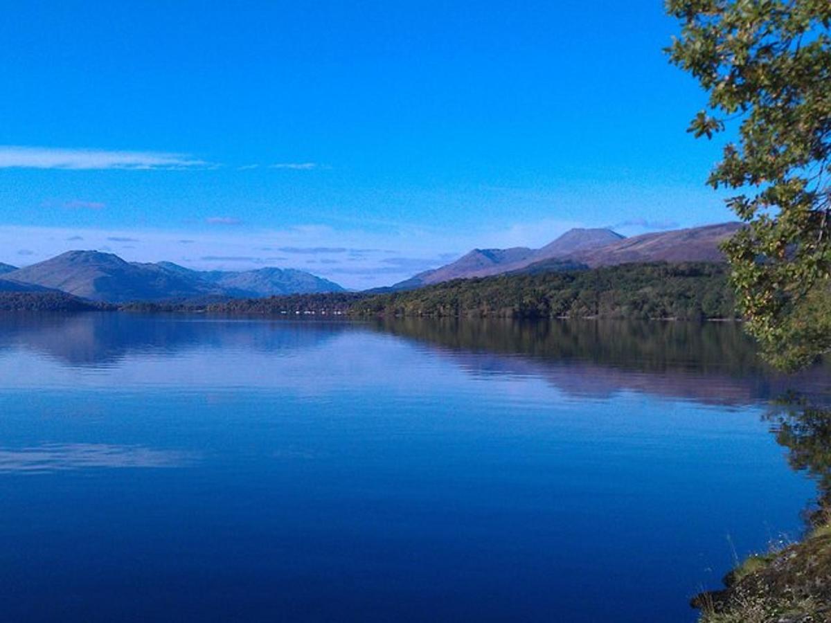 a large blue lake with mountains in the background