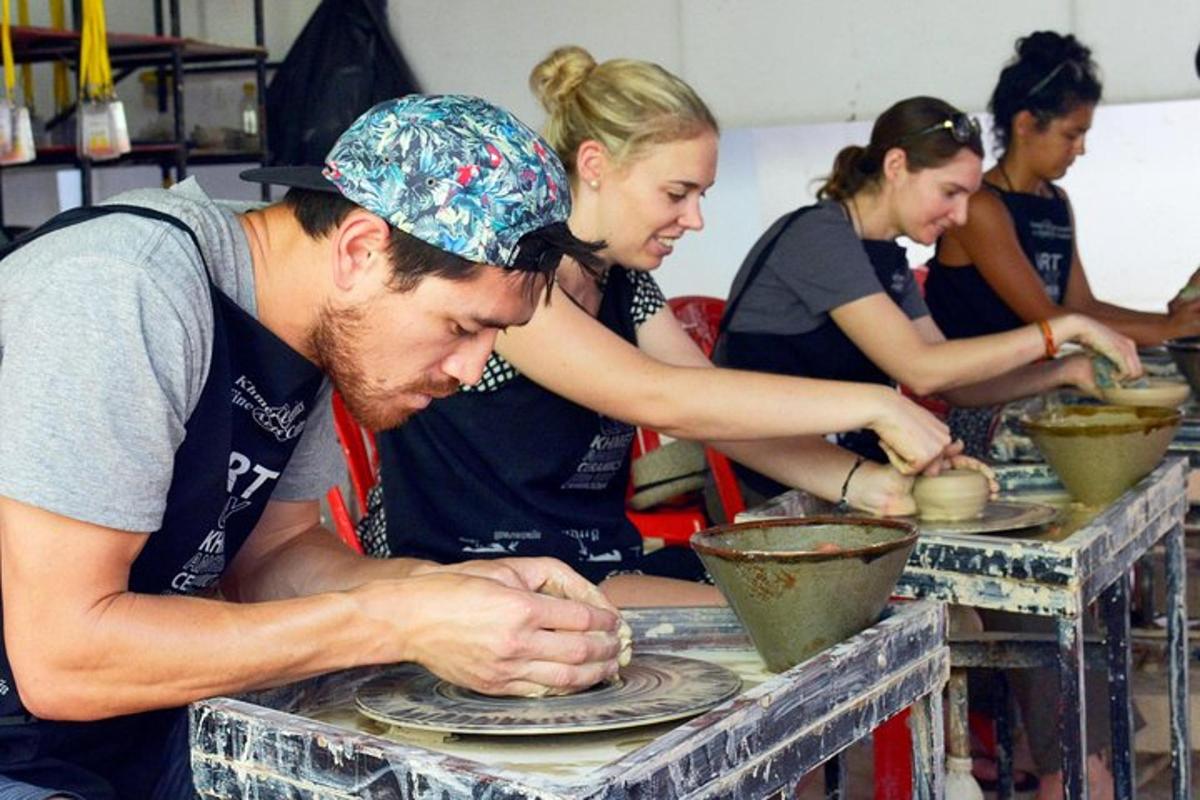 a group of people making plates on a table