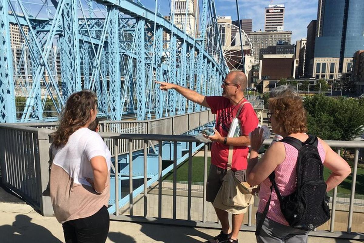 a group of people standing in front of a bridge