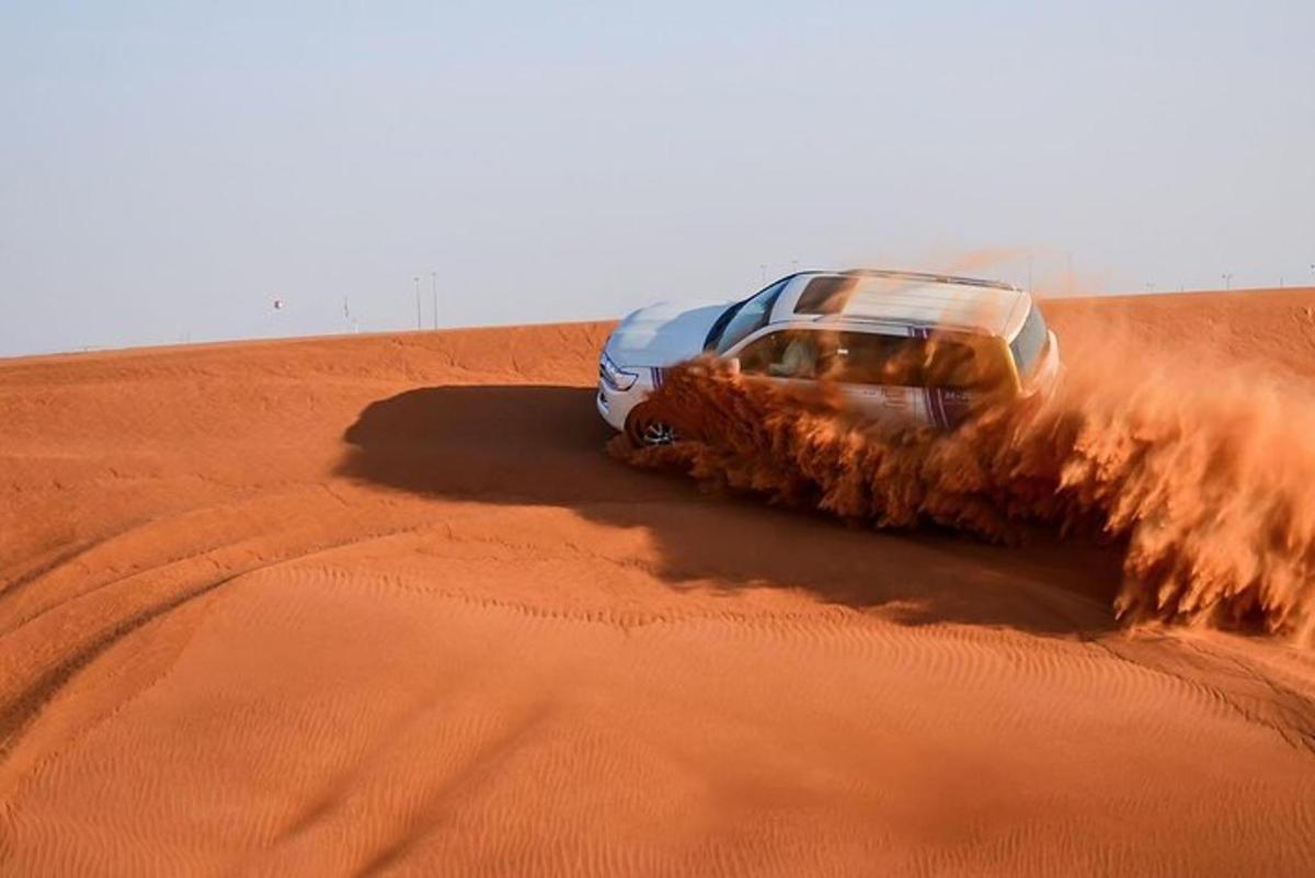 a car driving through the sand in the desert