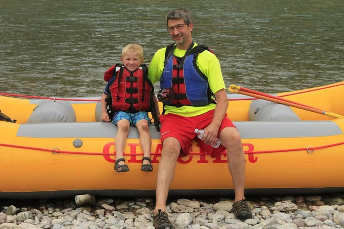 a man and a young boy sitting in a raft