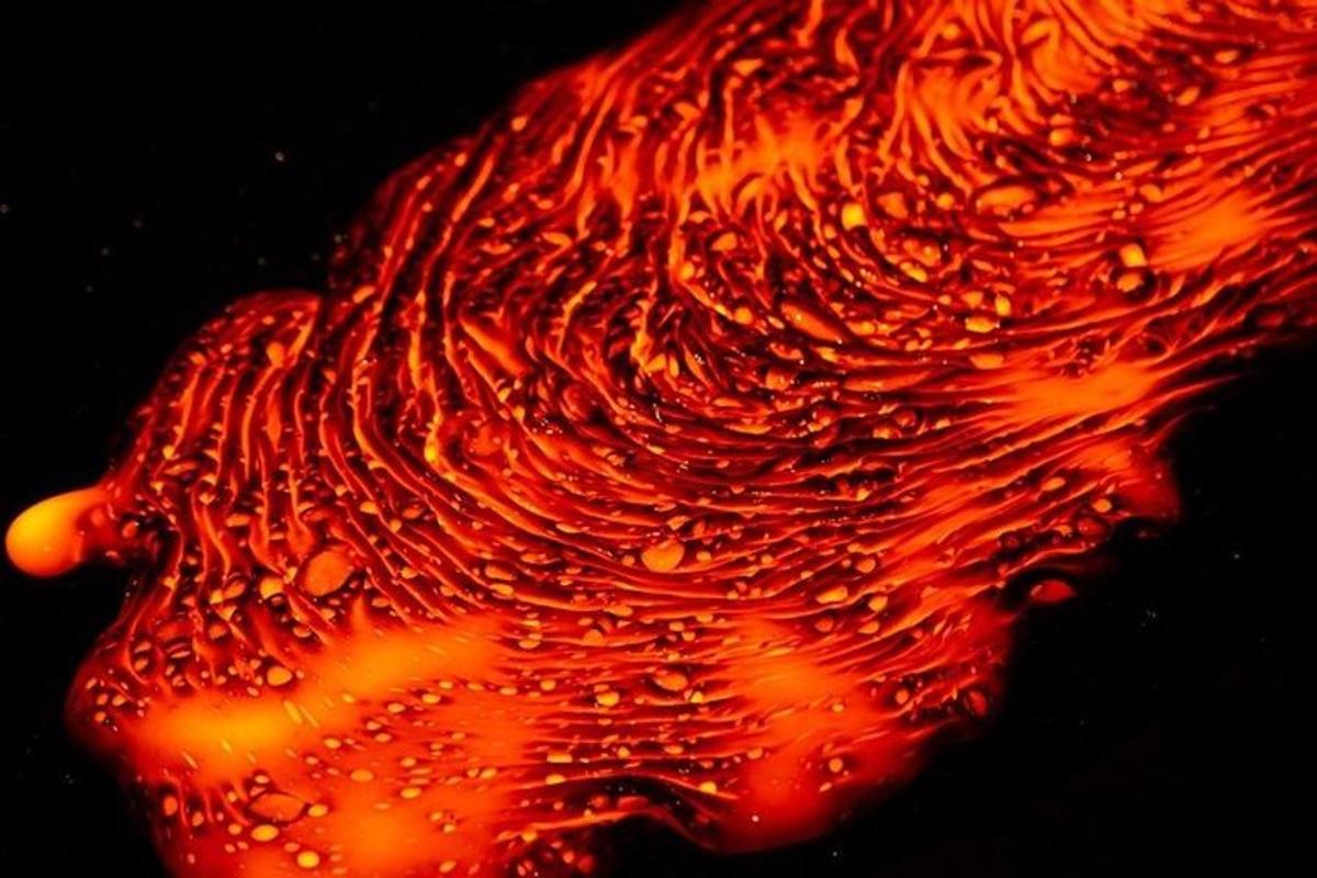 a close up of a fruit with water on it