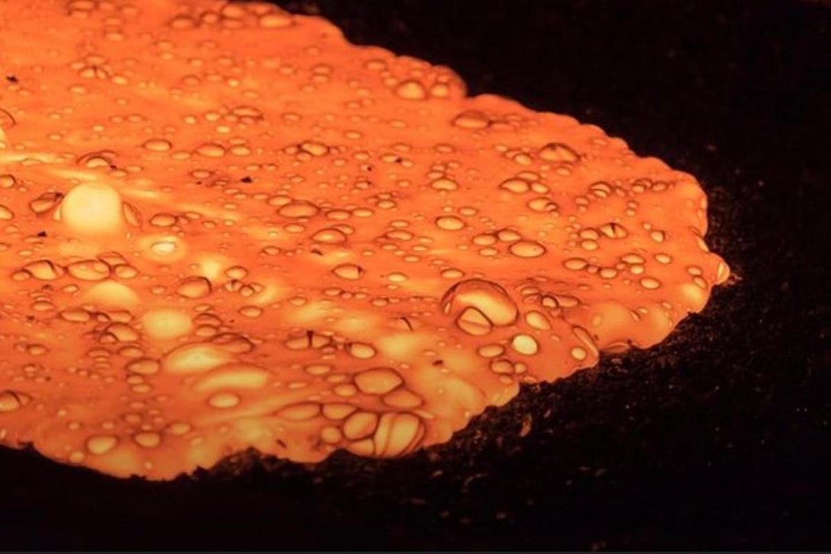 an orange object with drops of water on it