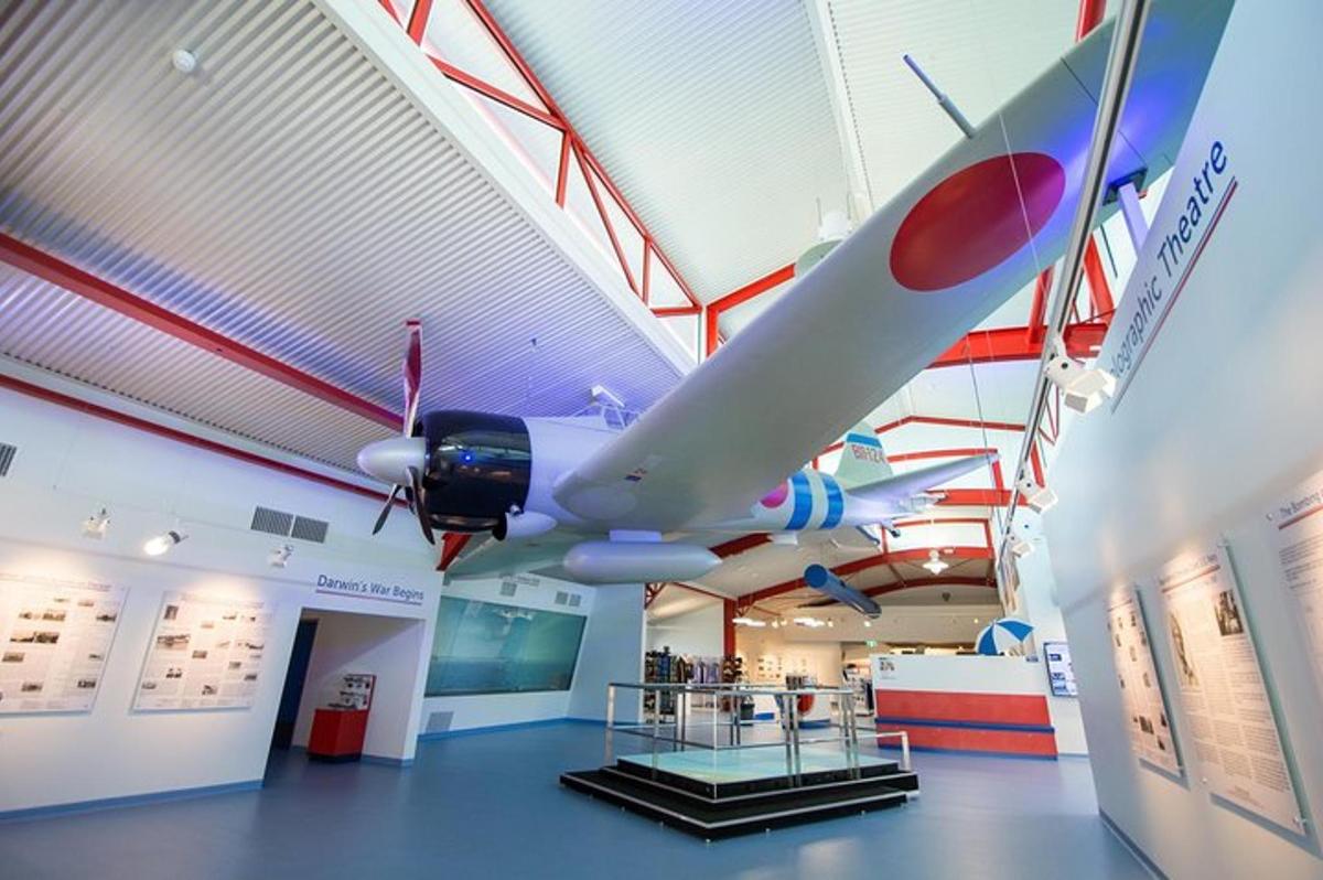 a museum with a plane hanging from the ceiling