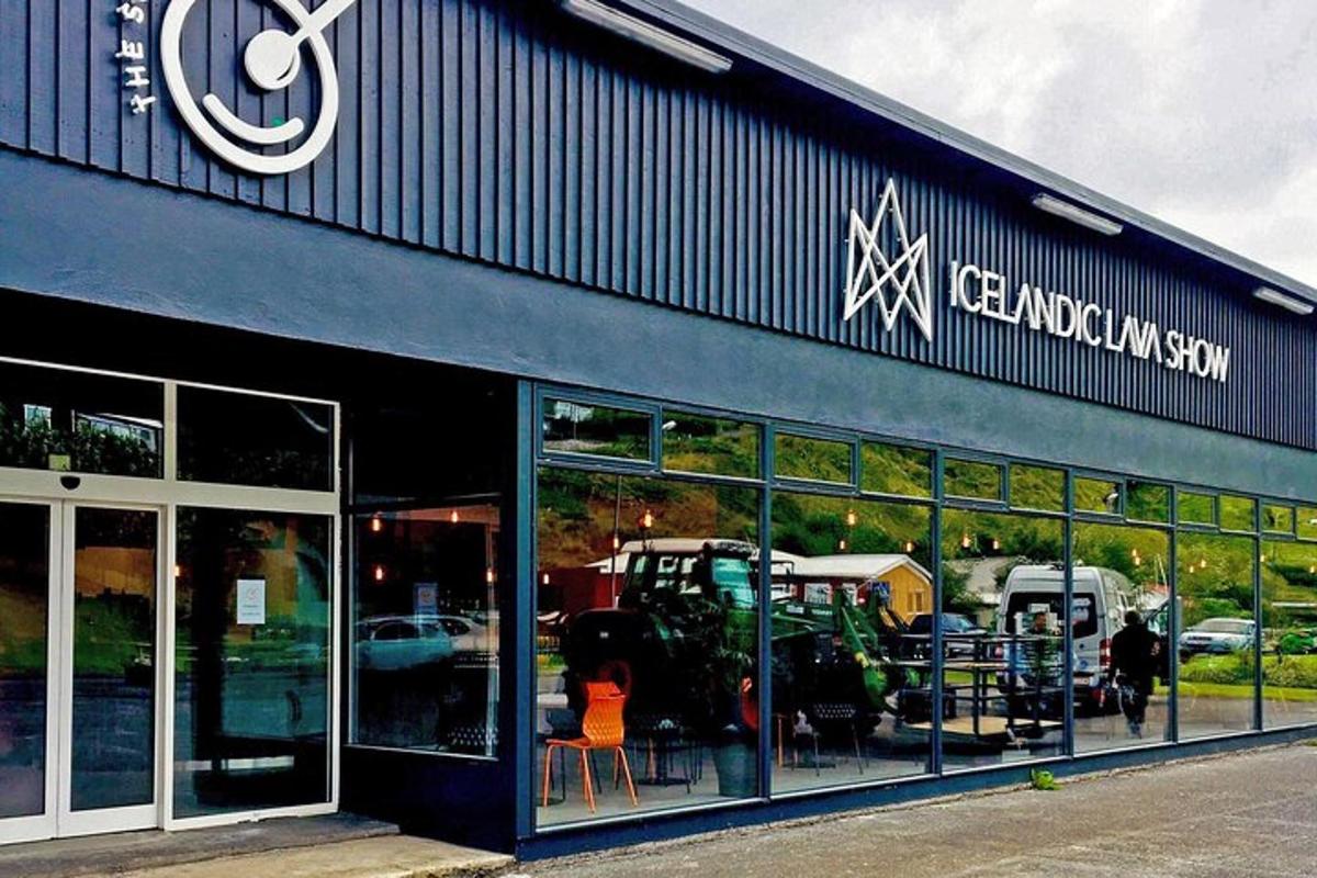 a store front of a dealership with tables and chairs