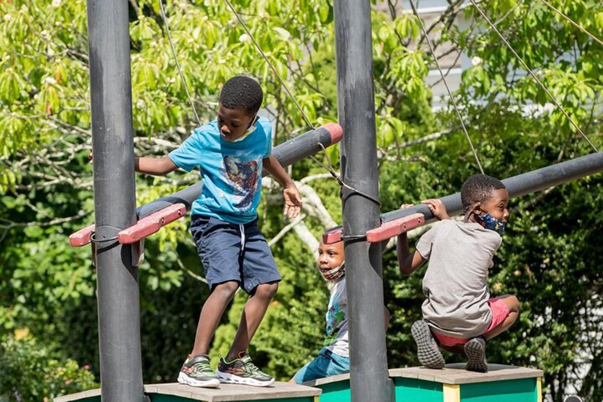 three young boys playing on a playground