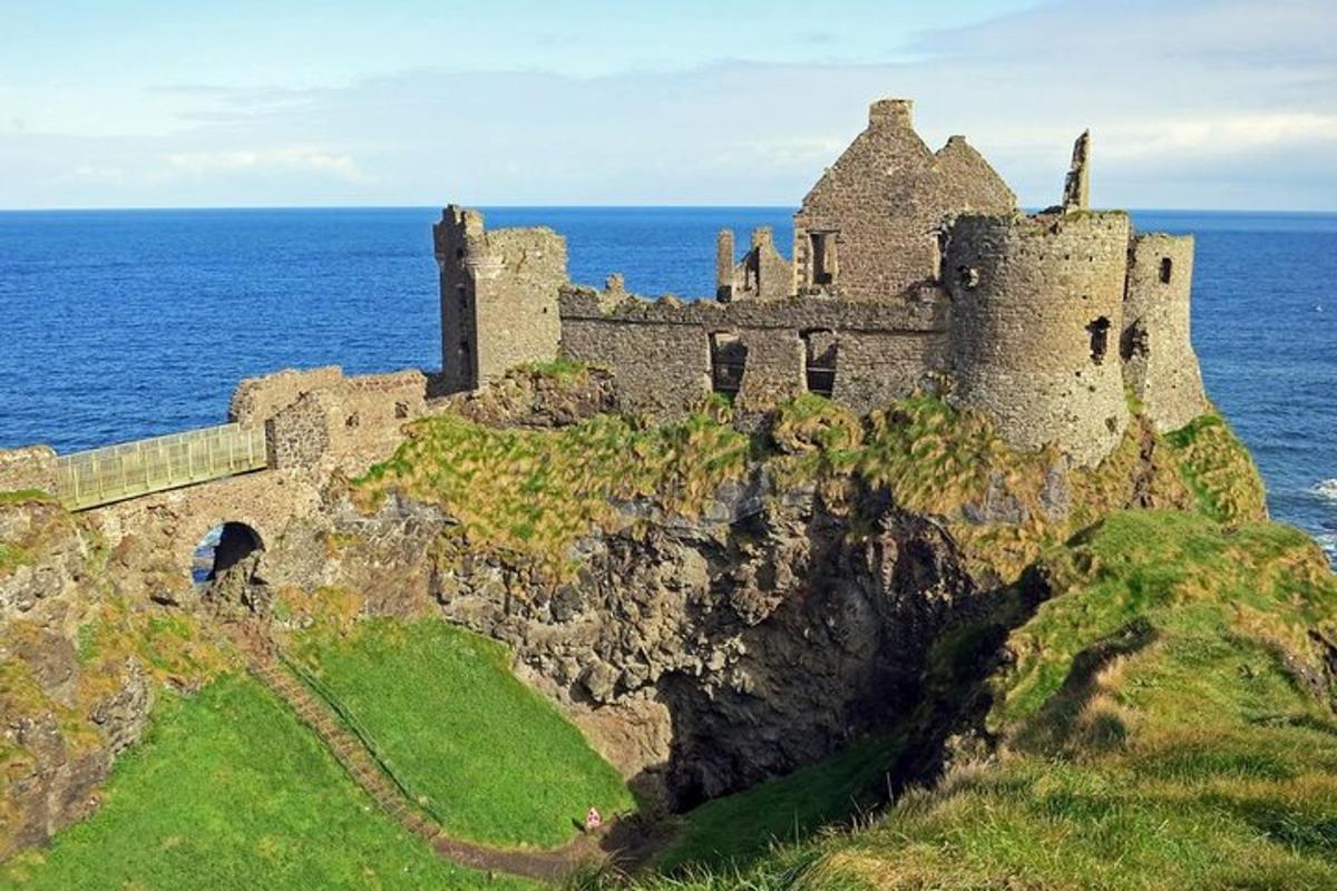 an old castle on a cliff in the ocean