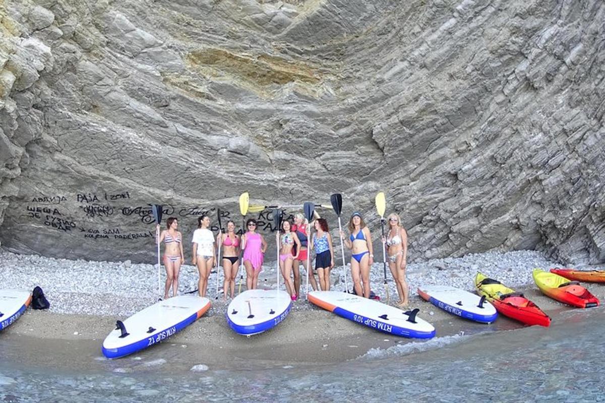um grupo de pessoas em pé na água com suas pranchas de surfe