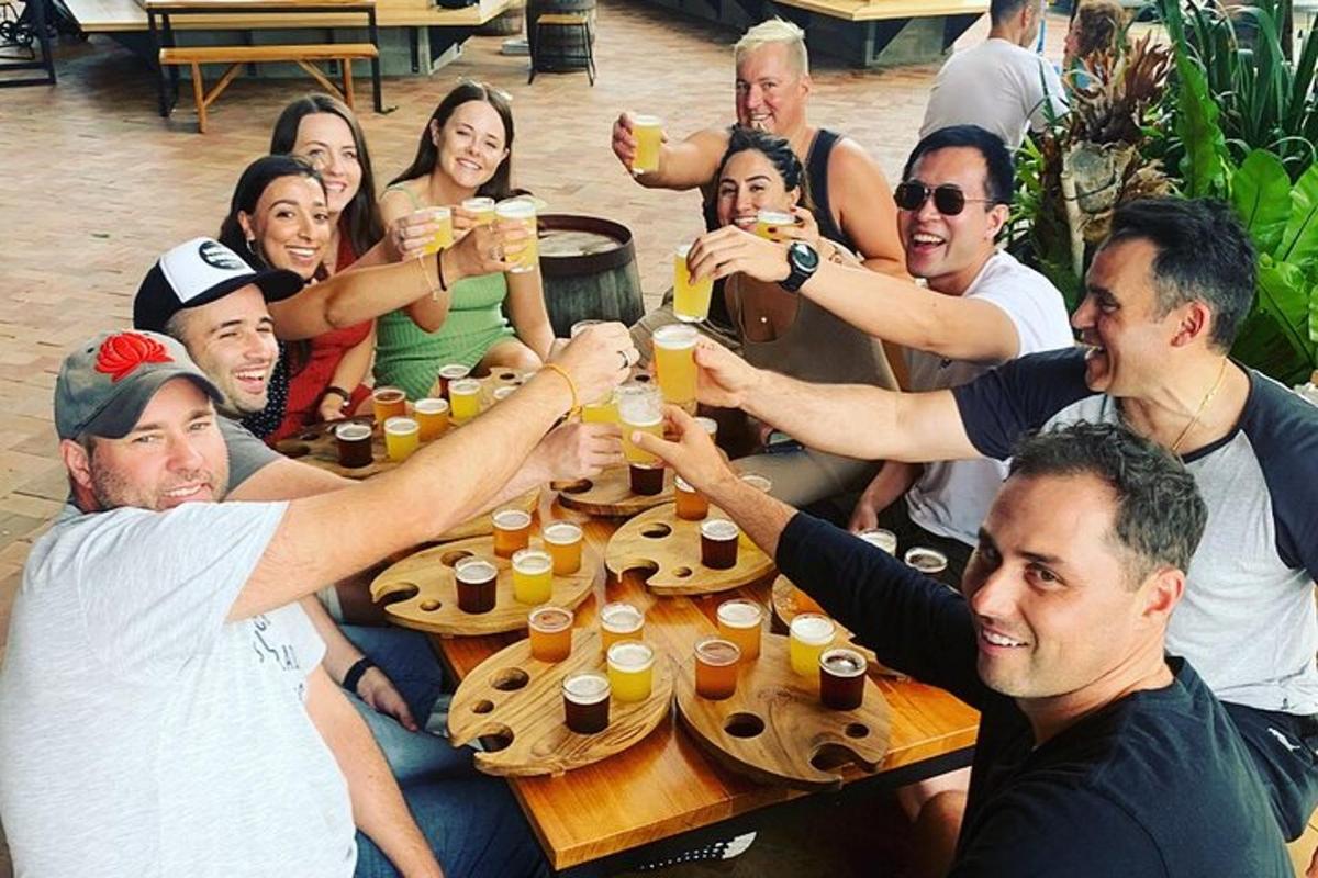 a group of people sitting around a table drinking beer