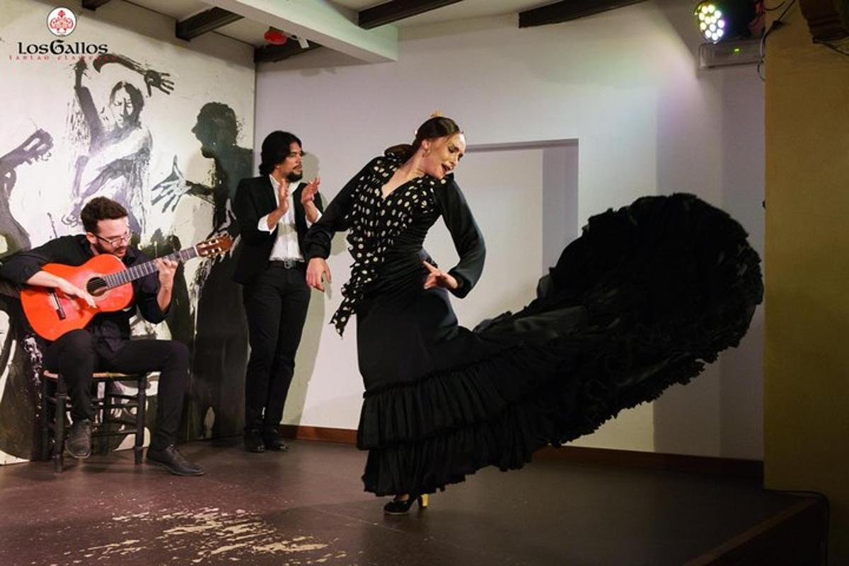 a woman in a dress dancing in a room with a guitar