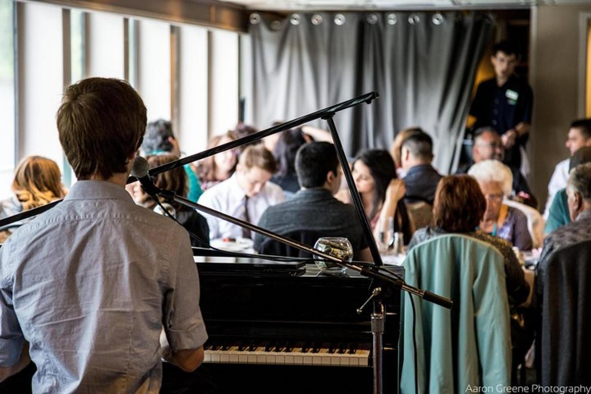 a man playing a piano in a crowd of people